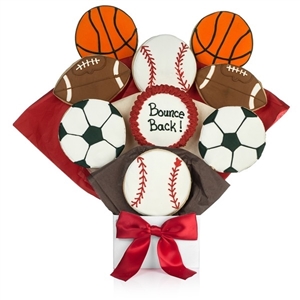 Bouquet of sugar cookies shaped and decorated like basketballs, footballs, soccer balls, and basketballs with customized text on one cookie.