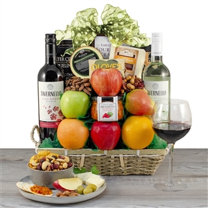 Bamboo basket with white wine, red wine, cheese and fruit