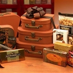 Gourmet Gift Tower is three tiered faux leather suitcases filled with treats