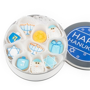 A round tin of iced vanilla sugar cookies decorated for Hanukkah.