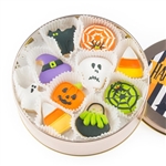 A round tin with 16 iced vanilla sugar cookies decorated for Halloween.