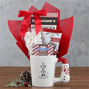 A ceramic mug filled with things for a hot chocolate oasis. ooden Gift Crate with a Thank You ribbon filled with dried fruit and nuts
