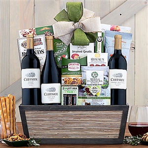 A gourmet gift basket with three red wines and Assortment of Goodies