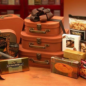 Gourmet Gift Tower is three tiered faux leather suitcases filled with treats